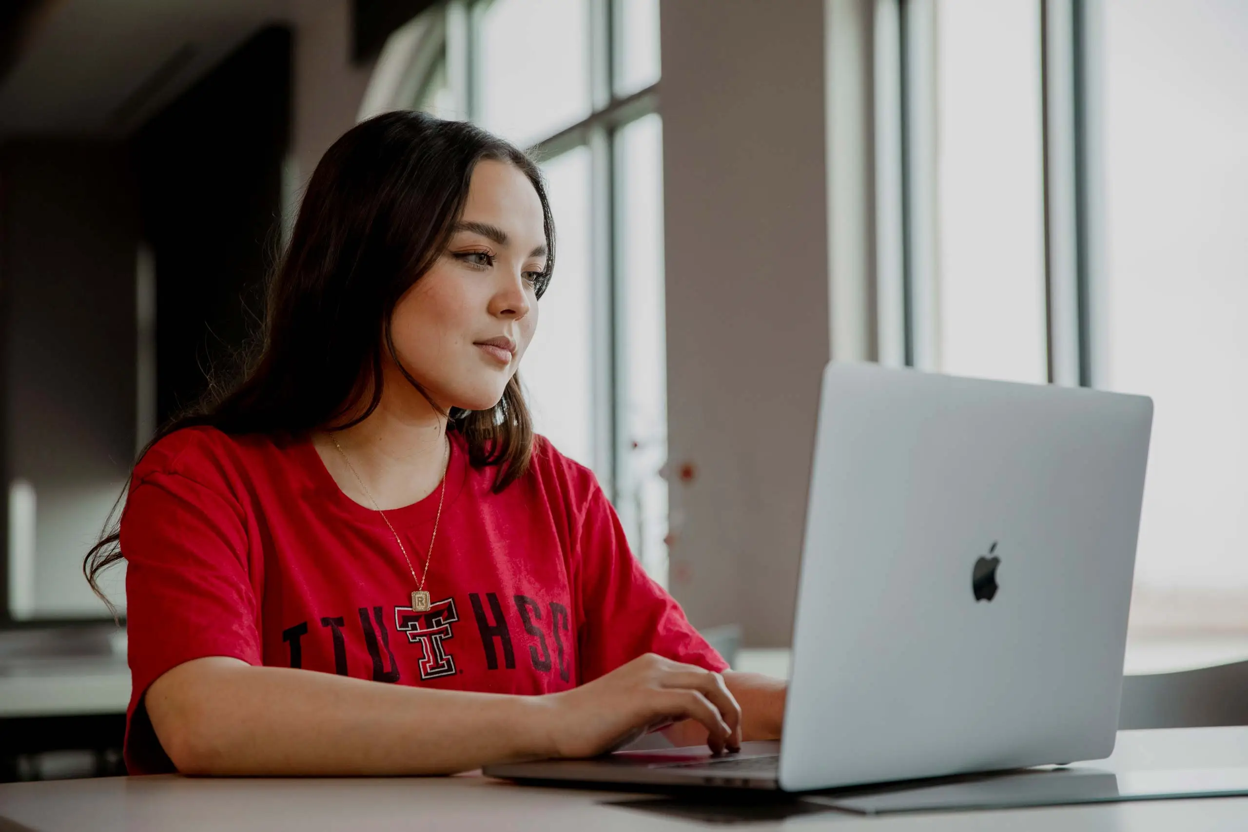 Student utilizing a laptop, representing online learning programs at Texas Tech University Health Sciences Center.