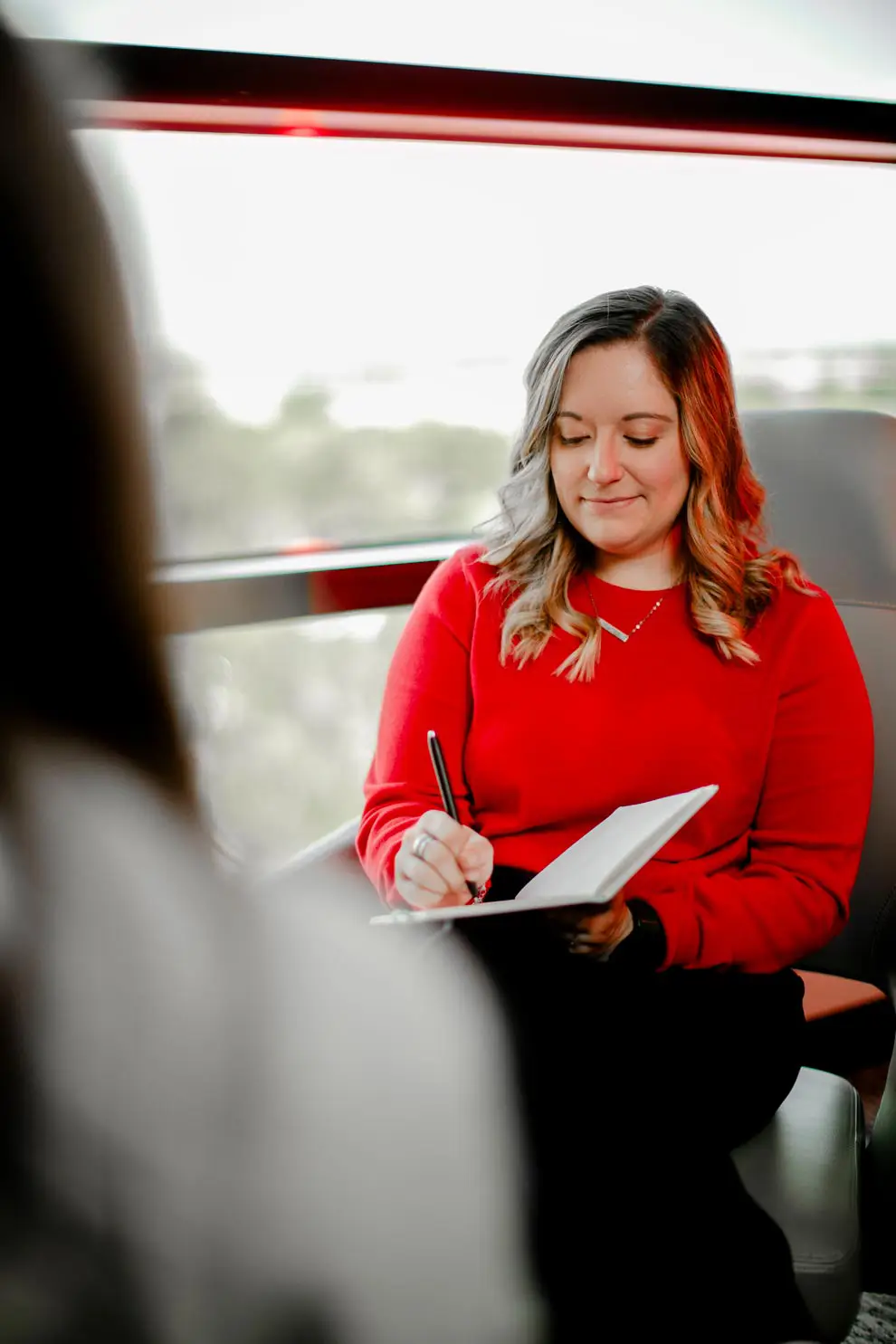 Clinical rehabilitation counseling student taking notes during a client counseling session
